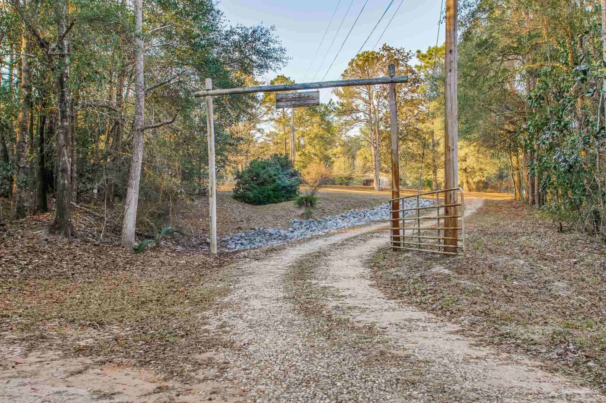 5150-5172 Siripon Road Milton, FL 32570 - Photo 2 of 54 a view of a yard with wooden fence
