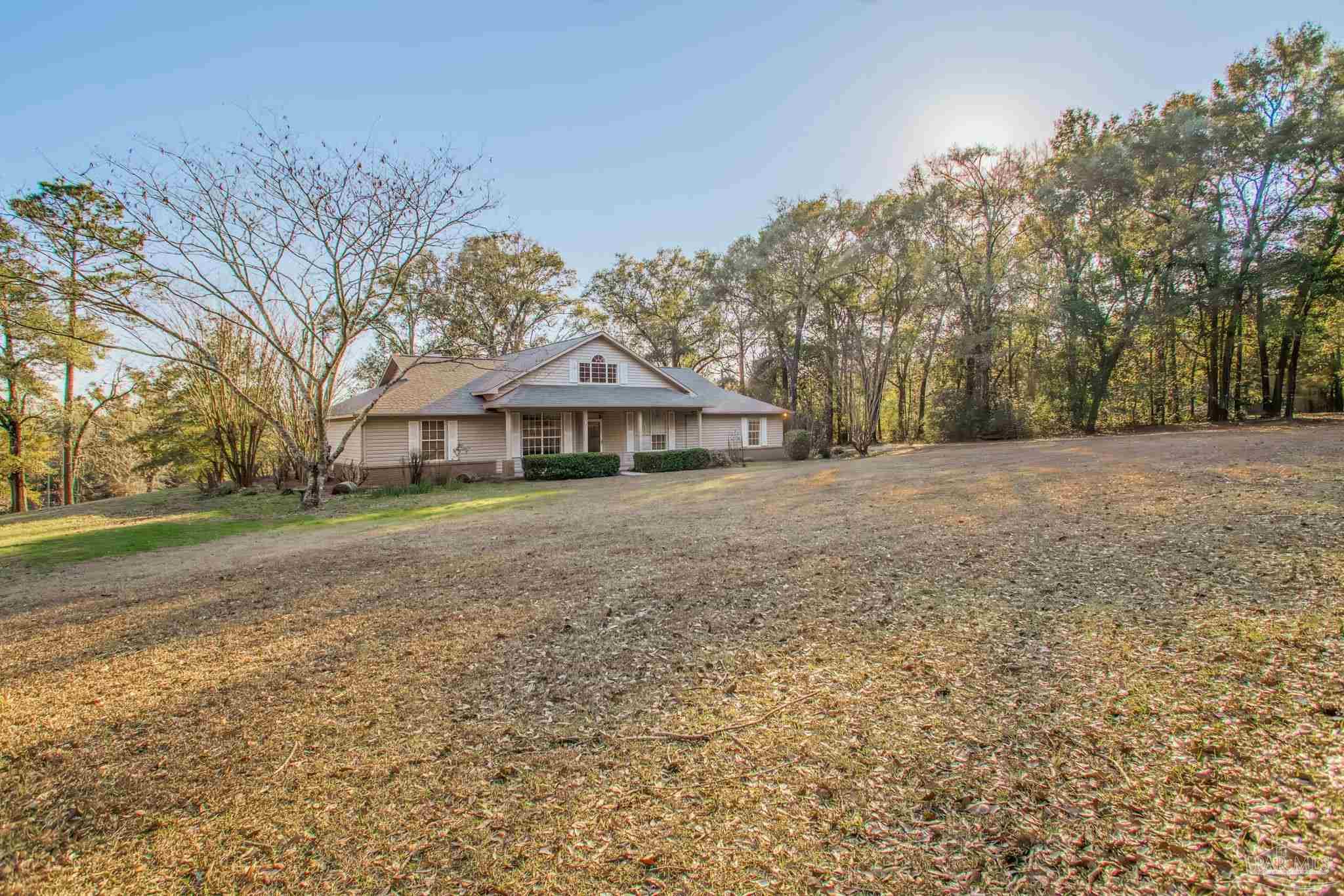 5150-5172 Siripon Road Milton, FL 32570 - Photo 23 of 54 a front view of a house with a yard