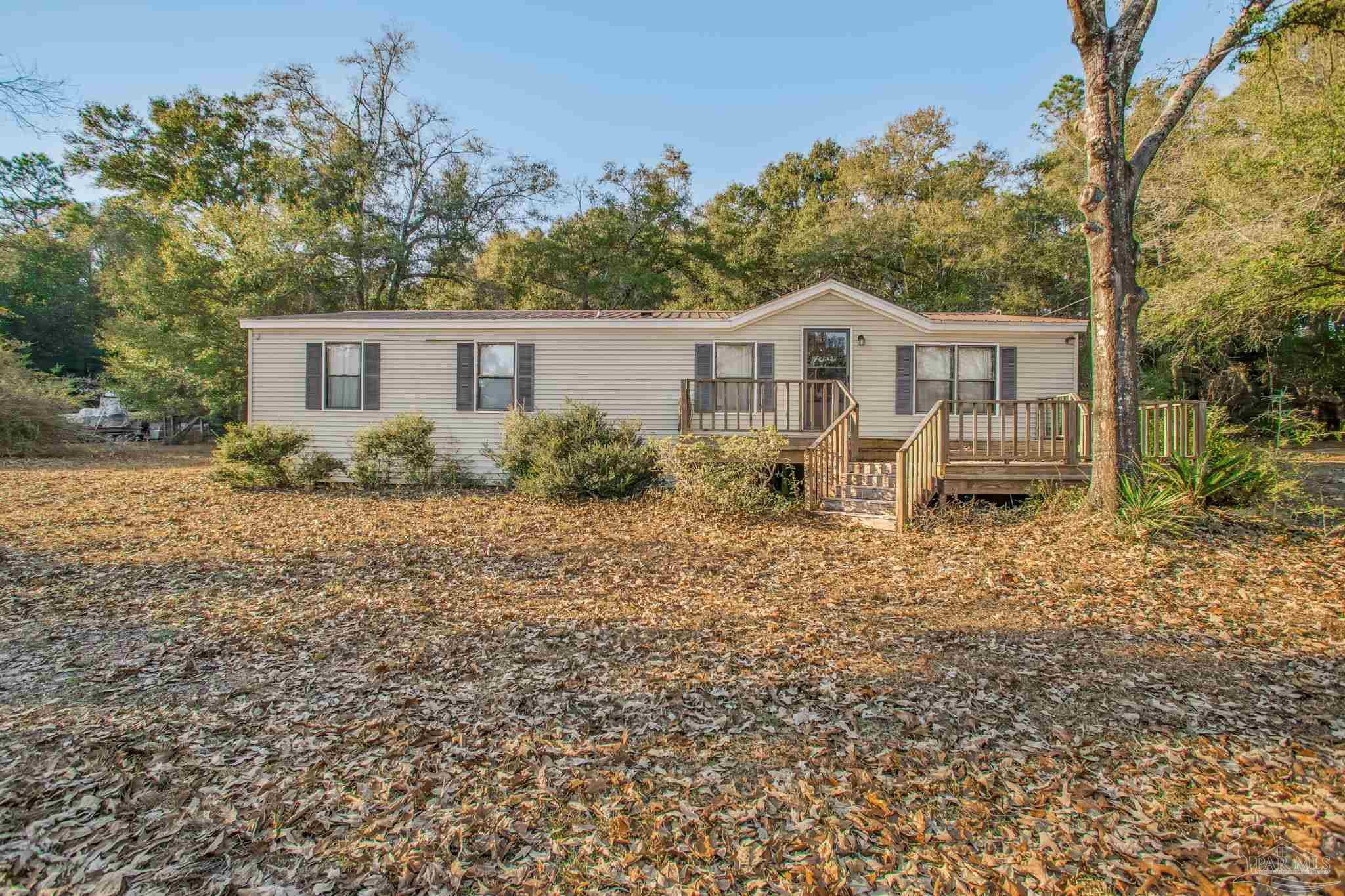 5150-5172 Siripon Road Milton, FL 32570 - Photo 25 of 54 a front view of a house with garden