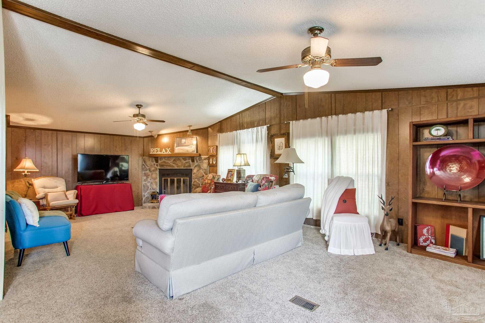 5150-5172 Siripon Road Milton, FL 32570 - Photo 28 of 54 a living room with furniture and a flat screen tv