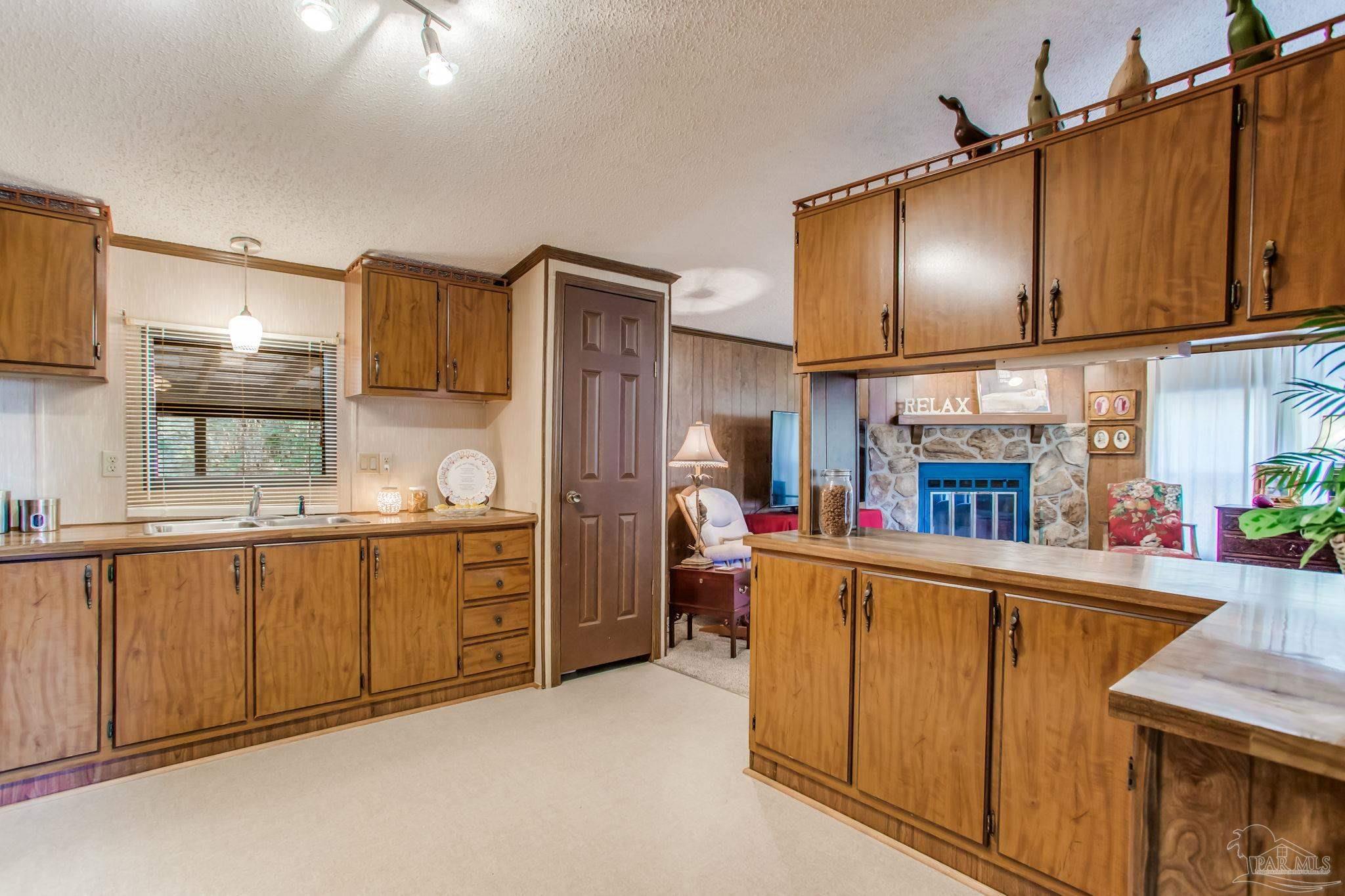 5150-5172 Siripon Road Milton, FL 32570 - Photo 29 of 54 a kitchen with stainless steel appliances granite countertop a sink stove and refrigerator