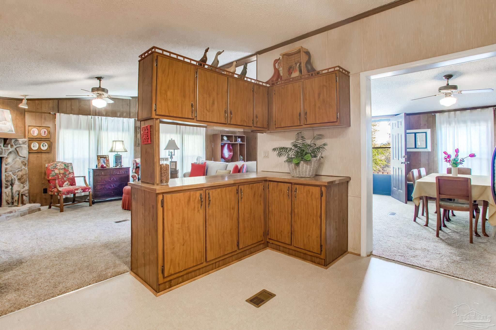 5150-5172 Siripon Road Milton, FL 32570 - Photo 30 of 54 a living room with furniture a dining table and a fireplace