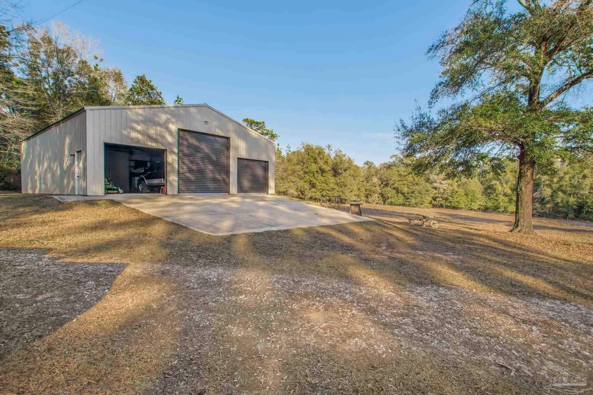 5150-5172 Siripon Road Milton, FL 32570 - Photo 3 of 54 a front view of a house with a yard and garage