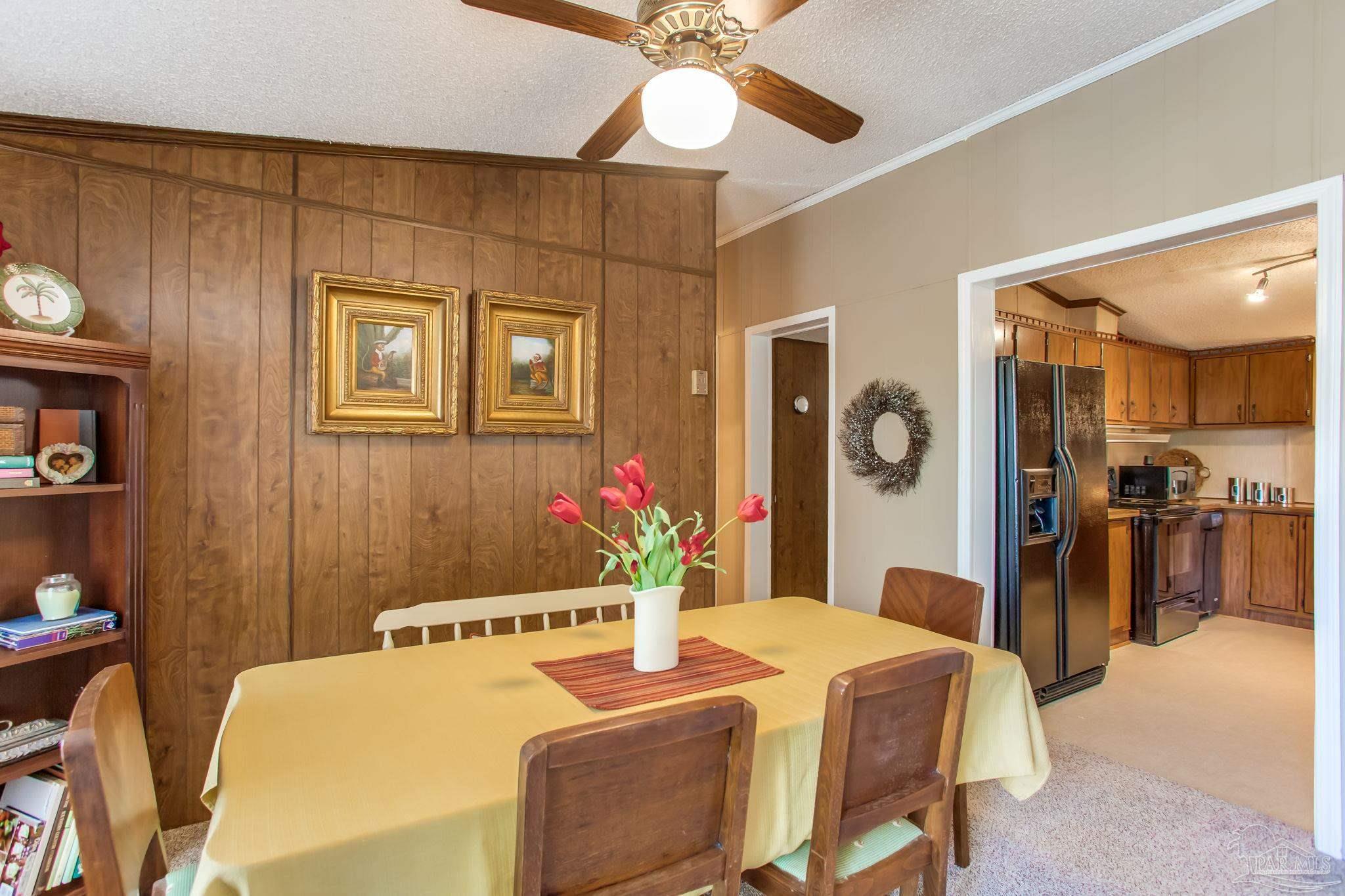 5150-5172 Siripon Road Milton, FL 32570 - Photo 34 of 54 a bedroom with a bed and a chandelier