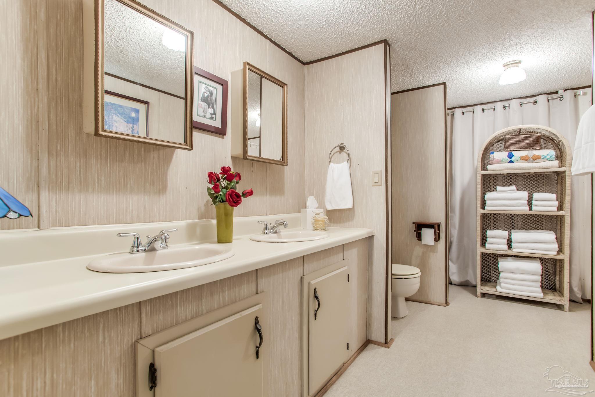 5150-5172 Siripon Road Milton, FL 32570 - Photo 36 of 54 a bathroom with a sink vanity and a mirror