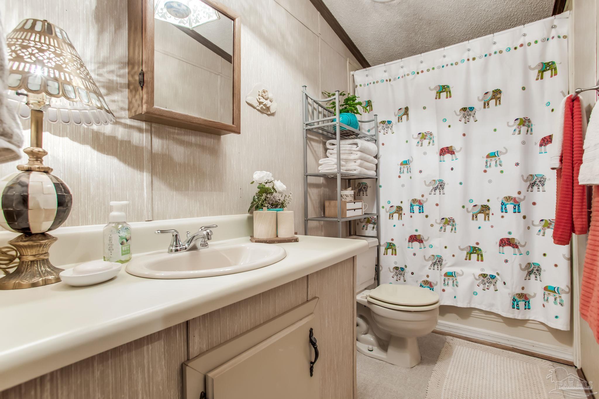 5150-5172 Siripon Road Milton, FL 32570 - Photo 38 of 54 a bathroom with a sink toilet and shower