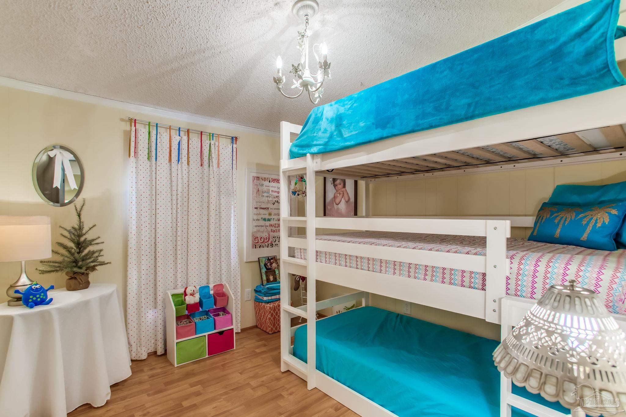 5150-5172 Siripon Road Milton, FL 32570 - Photo 39 of 54 a view of a bedroom with baby crib and furniture