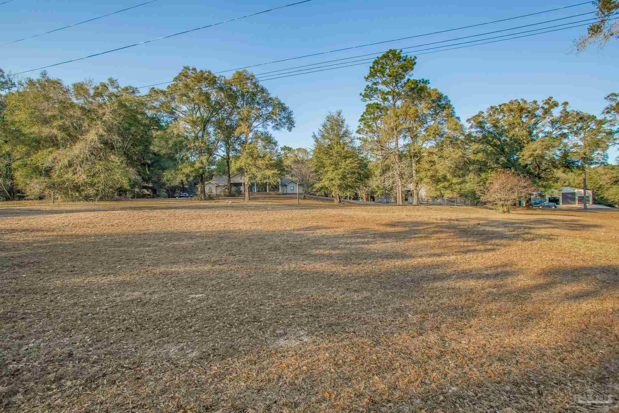 5150-5172 Siripon Road Milton, FL 32570 - Photo 43 of 54 a view of a yard with an outdoor space