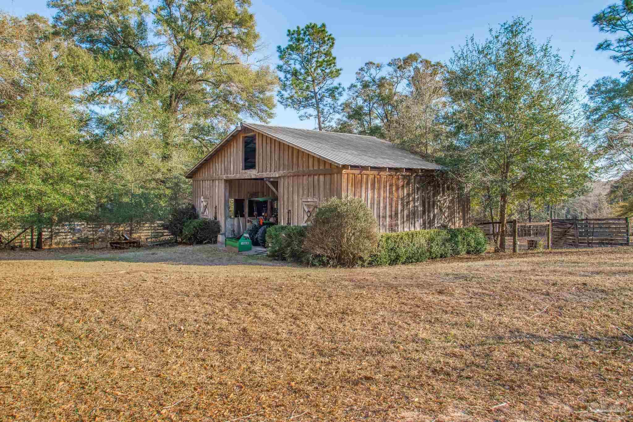 5150-5172 Siripon Road Milton, FL 32570 - Photo 5 of 54 a front view of a house with a garden