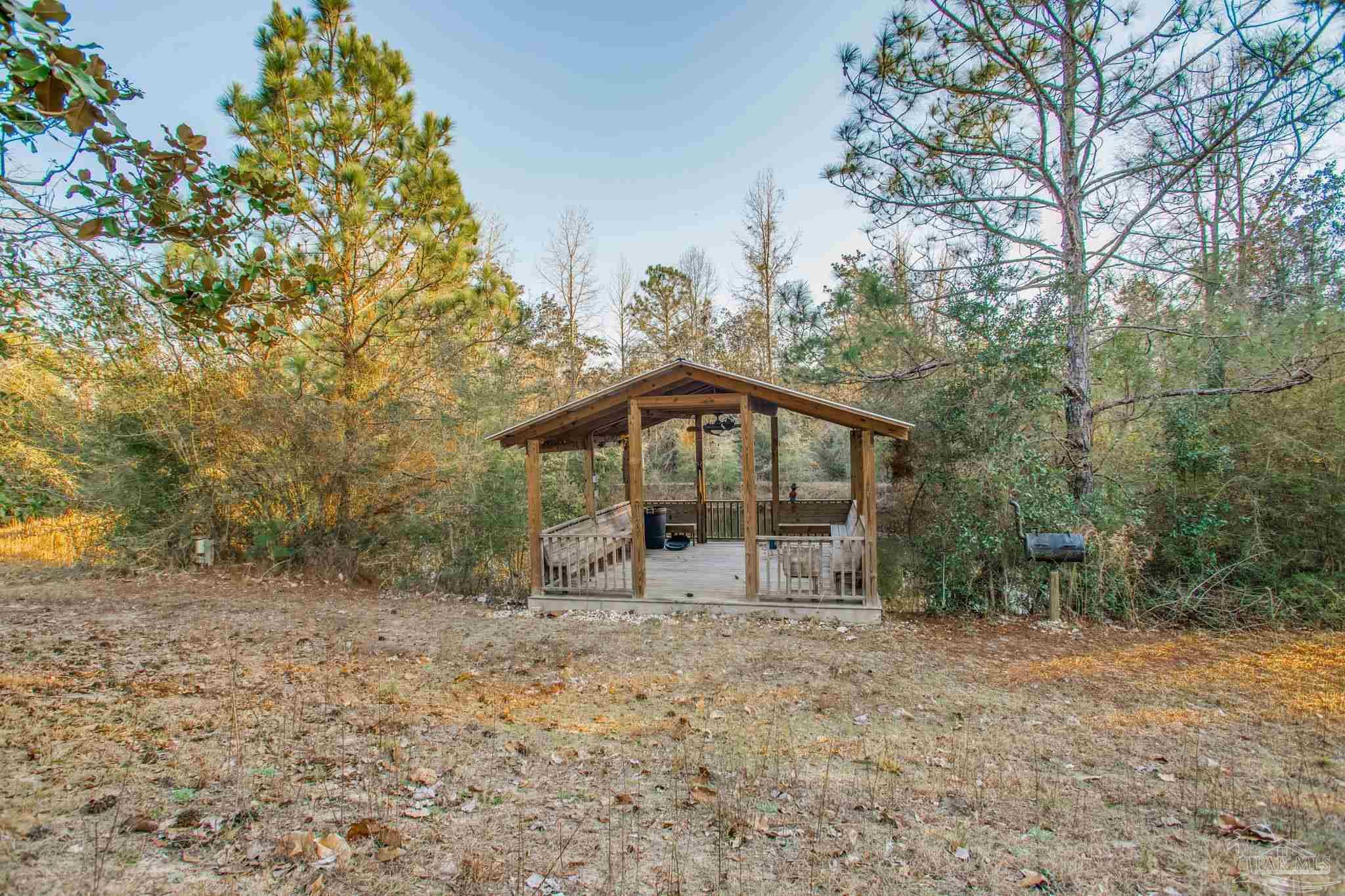 5150-5172 Siripon Road Milton, FL 32570 - Photo 53 of 54 a view of a house with a yard