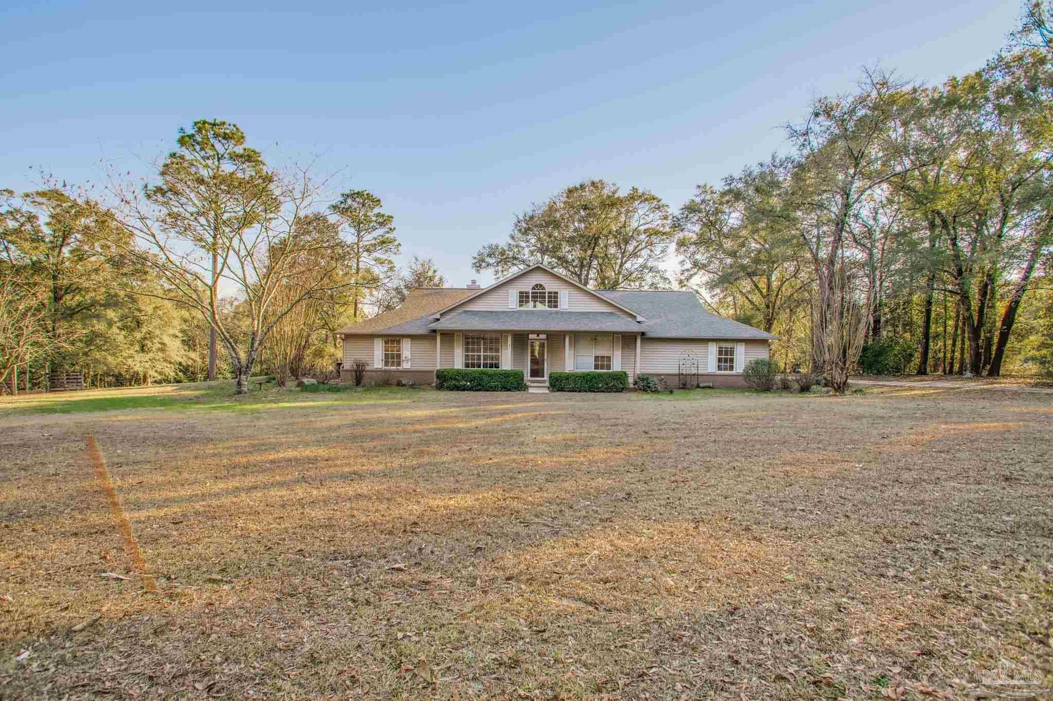 5150-5172 Siripon Road Milton, FL 32570 - Photo 6 of 54 a front view of a house with a garden