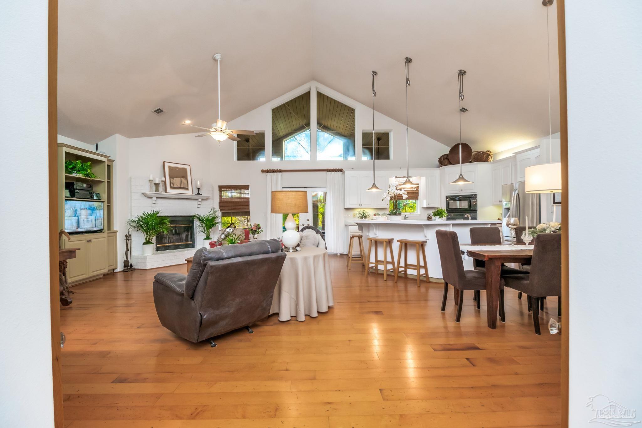 5150-5172 Siripon Road Milton, FL 32570 - Photo 7 of 54 a living room with fireplace furniture and a wooden floor