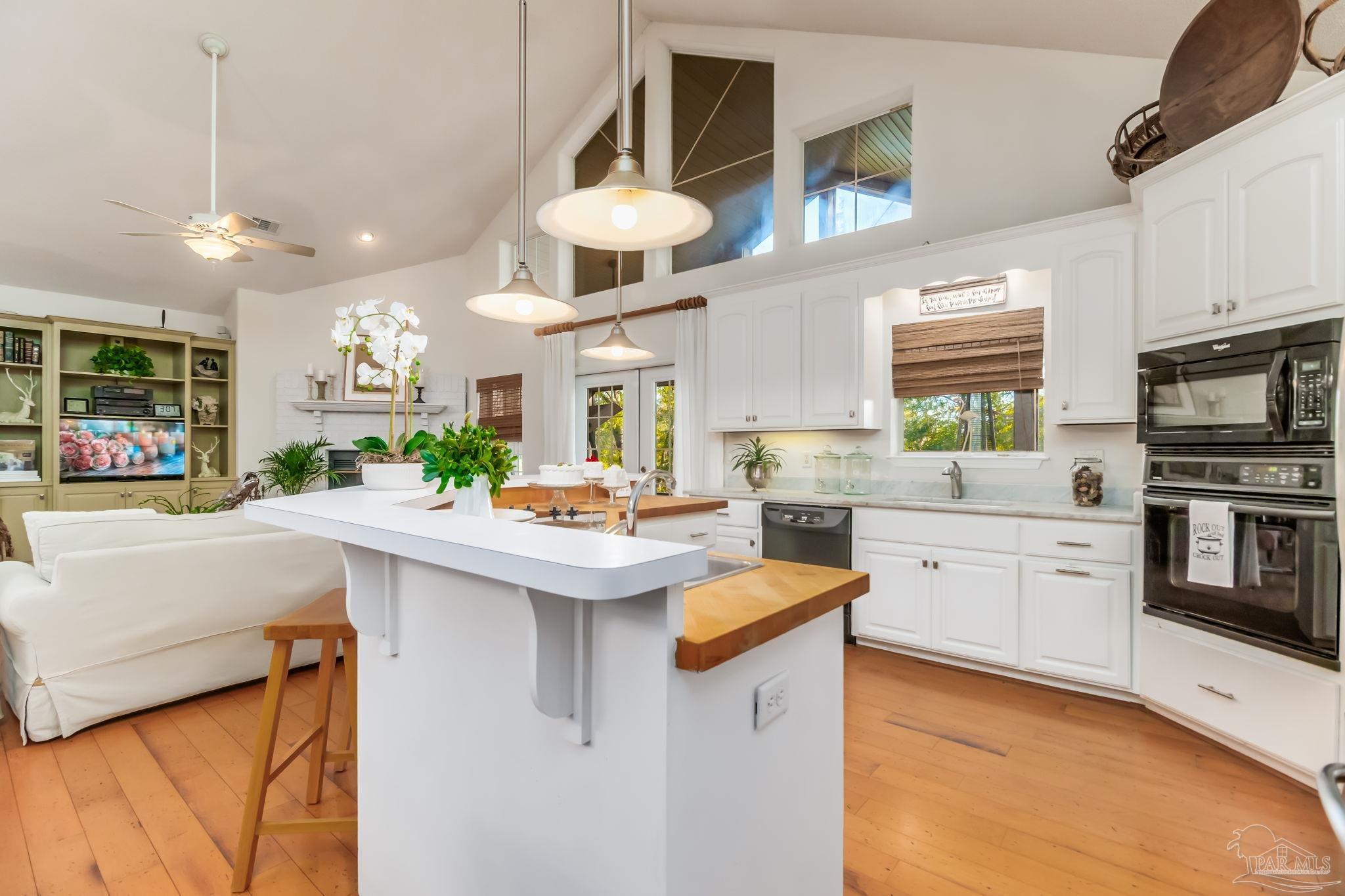 5150-5172 Siripon Road Milton, FL 32570 - Photo 8 of 54 a kitchen with stainless steel appliances kitchen island granite countertop a sink a stove and a refrigerator