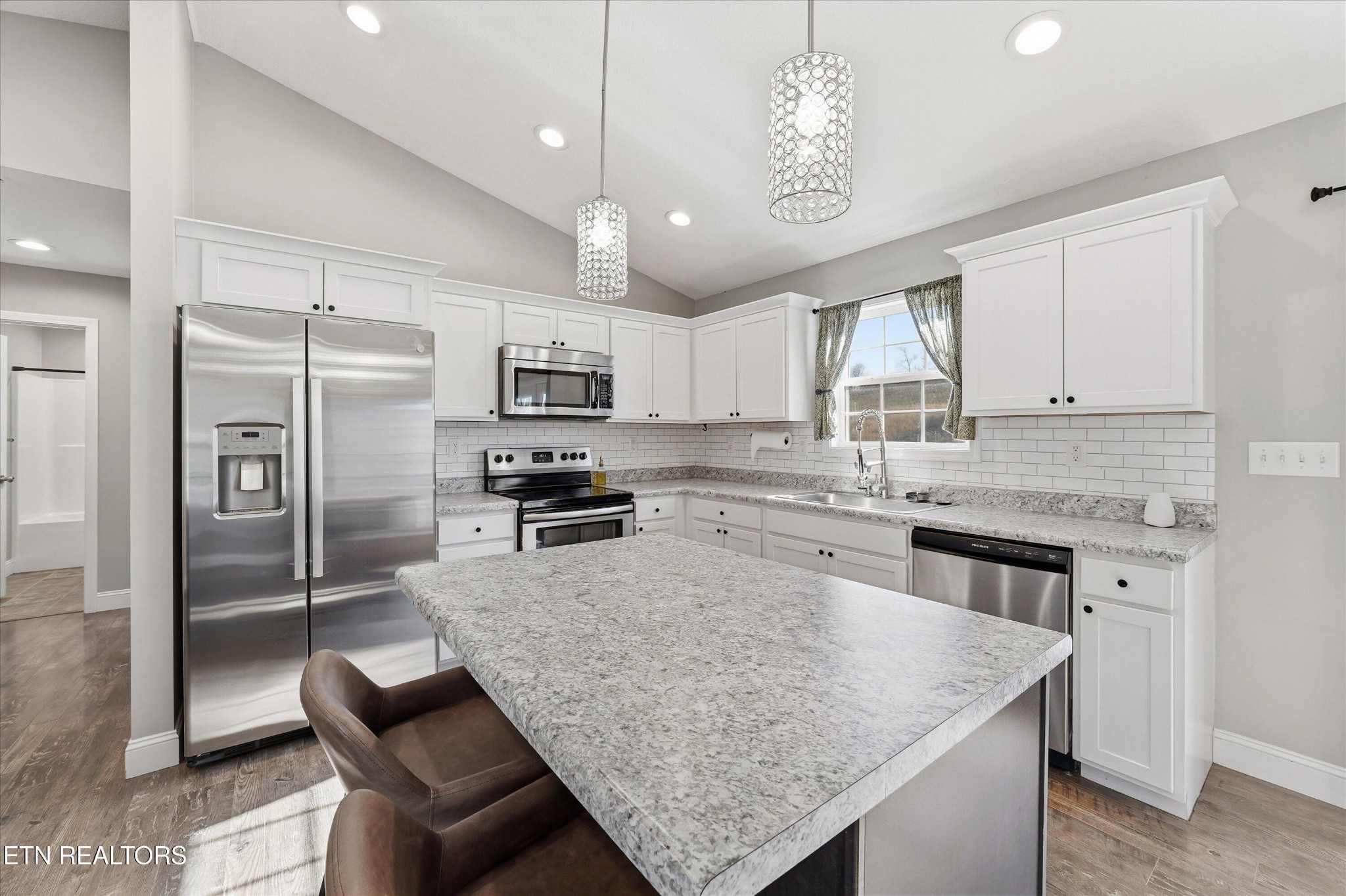 400 Hubbs Grove Road Maynardville, TN 37807 - Photo 16 of 46 a kitchen with stainless steel appliances granite countertop a sink a stove a refrigerator cabinets and a counter top space