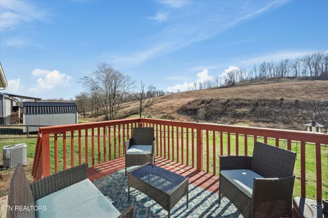 a roof deck with wooden floor and fence
