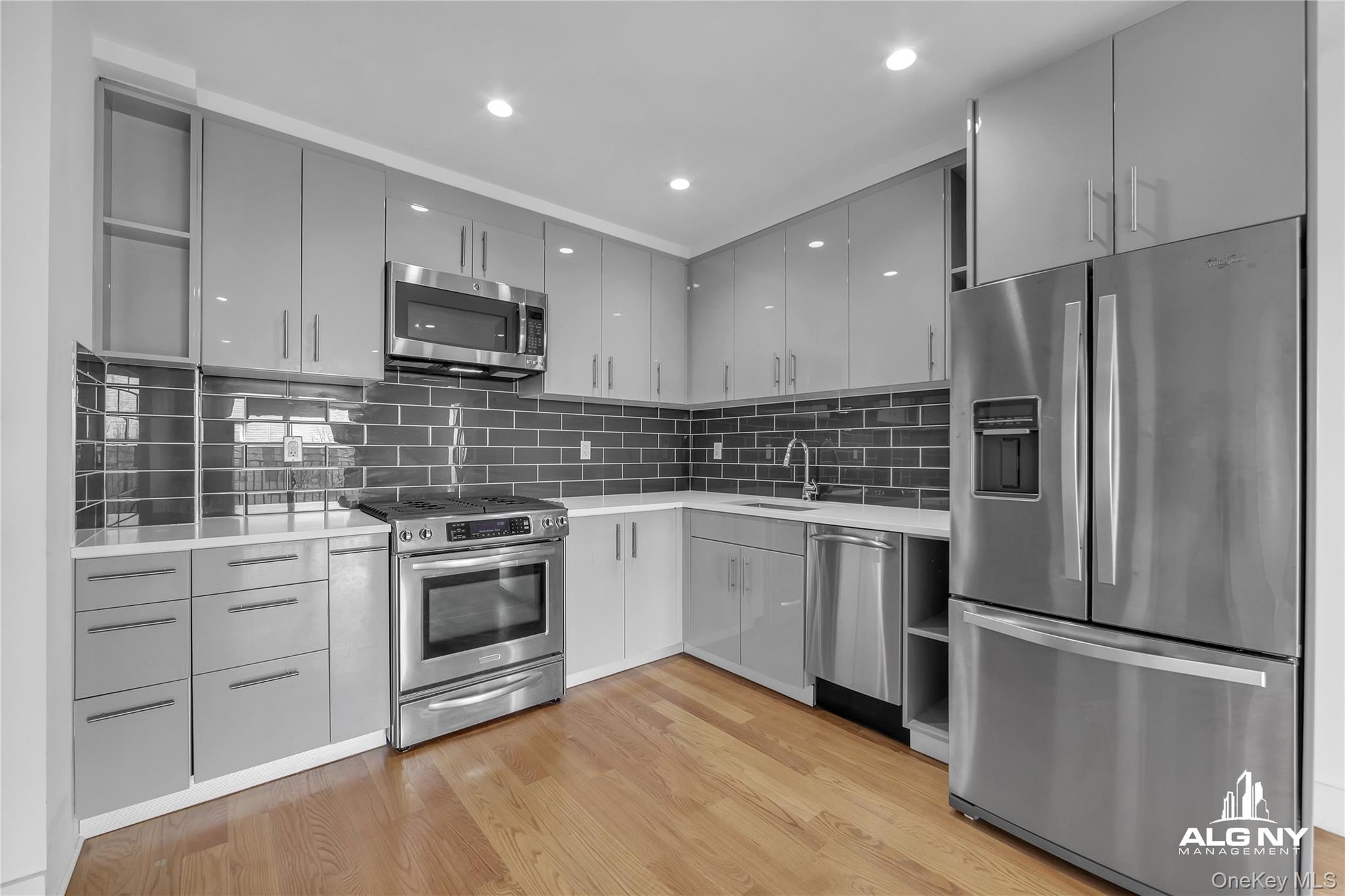 63-34 Fresh Pond Road, Unit 3G Queens, NY 11385 - Photo 3 of 6 a kitchen with a refrigerator sink and stove