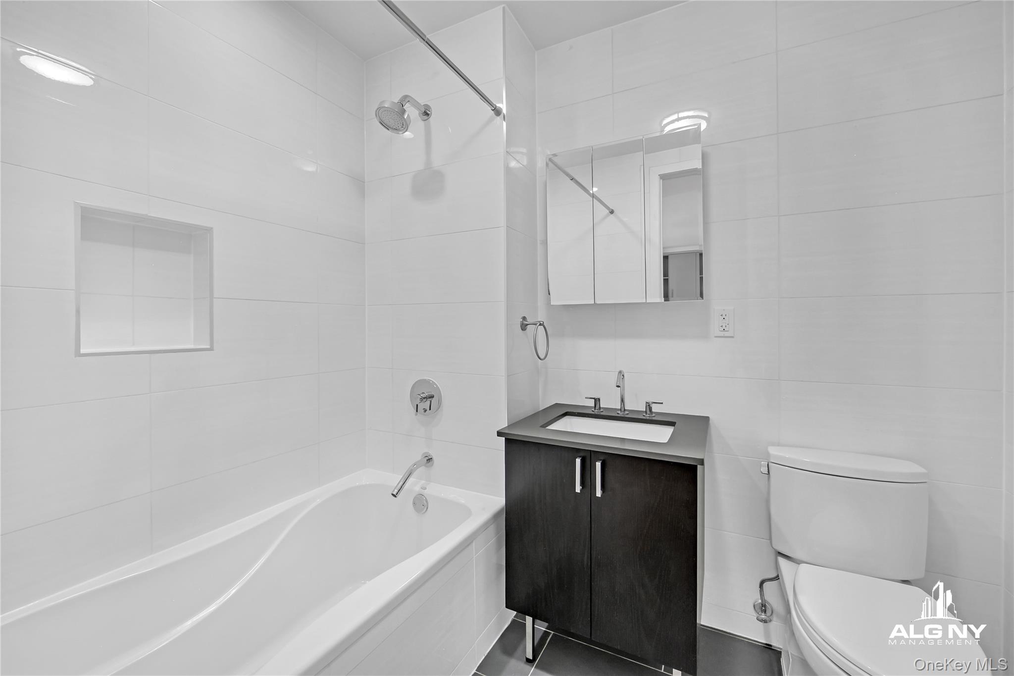 63-34 Fresh Pond Road, Unit 3G Queens, NY 11385 - Photo 4 of 6 a bathroom with a sink a toilet and bathtub