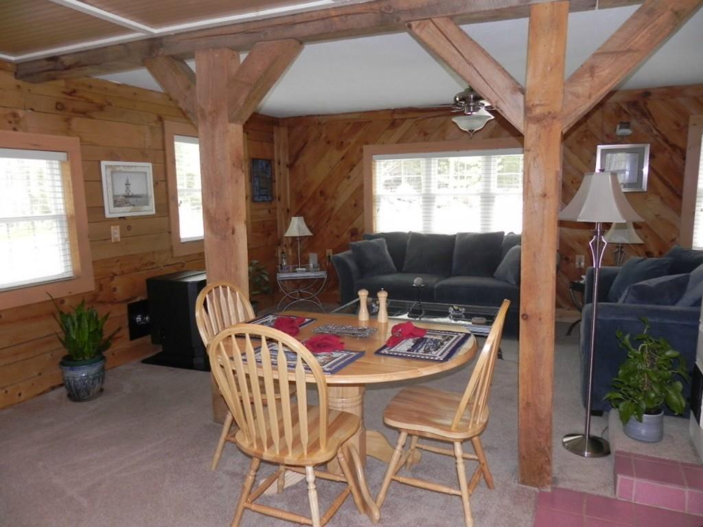 89 Peaked Mountain Road Sebago, ME 04029 - Photo 27 of 34 Dining area and living room in cottage