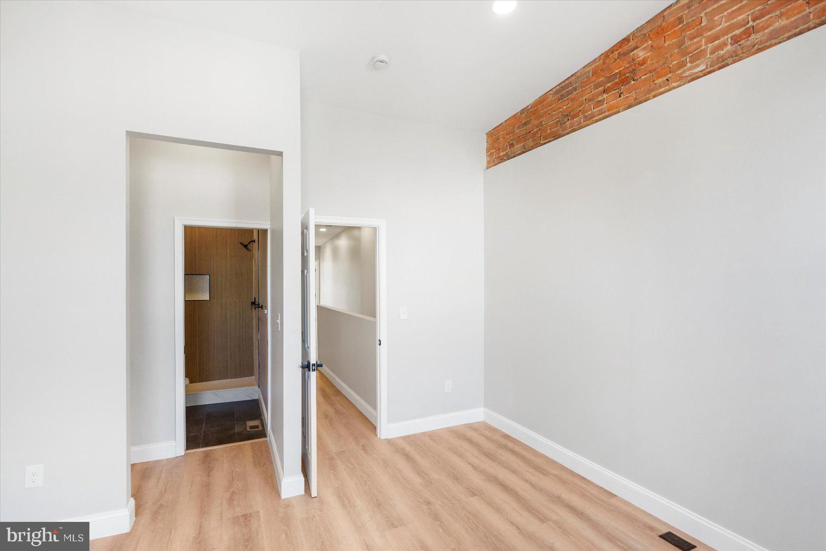 1415 East Lanvale Street Baltimore, MD 21213 - Photo 21 of 42 a view of a hallway with wooden floor