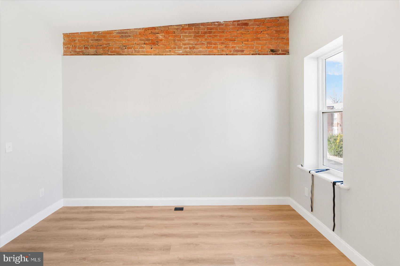 1415 East Lanvale Street Baltimore, MD 21213 - Photo 22 of 42 a view of a room with wooden floor and fence