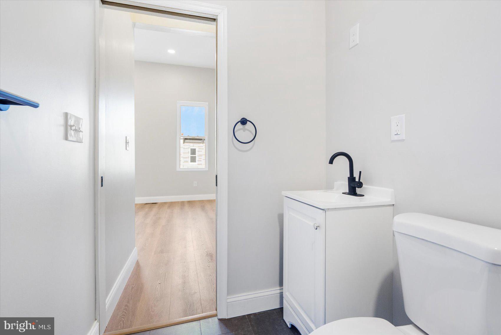 1415 East Lanvale Street Baltimore, MD 21213 - Photo 25 of 42 a bathroom with a toilet and a sink