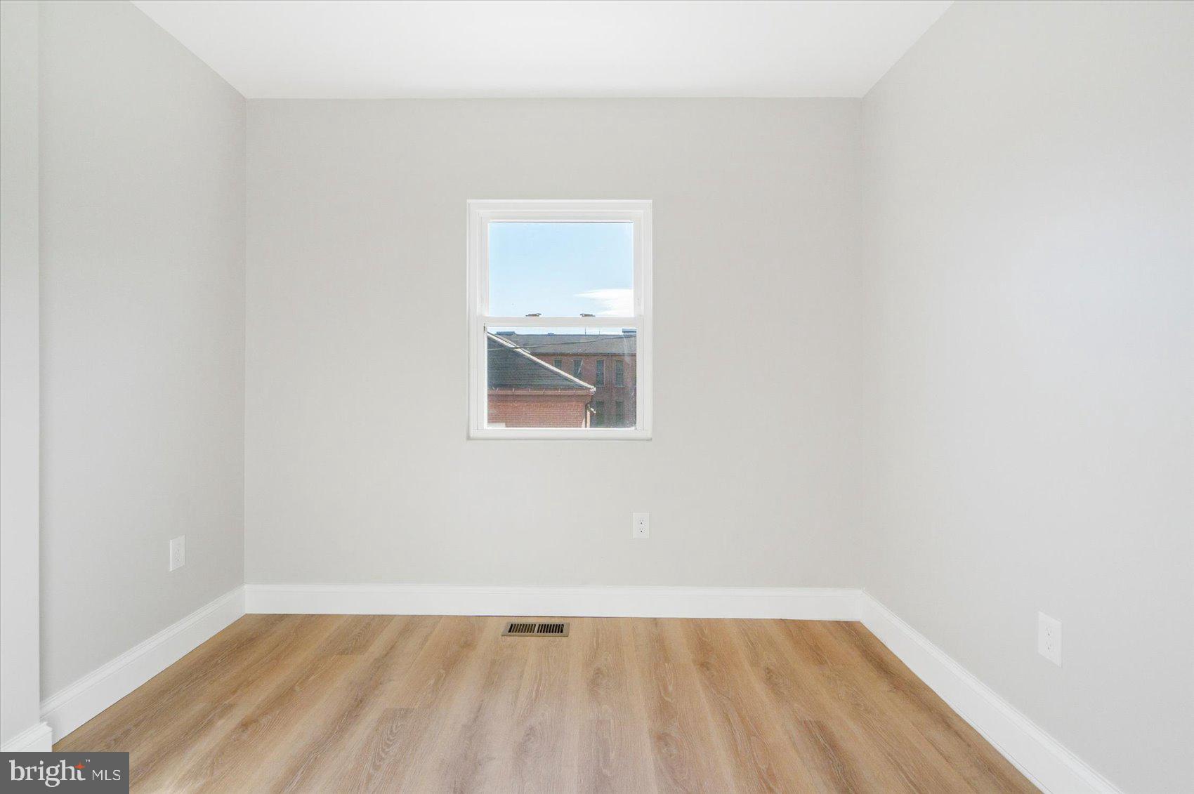1415 East Lanvale Street Baltimore, MD 21213 - Photo 31 of 42 a view of a small space with wooden floor and a window
