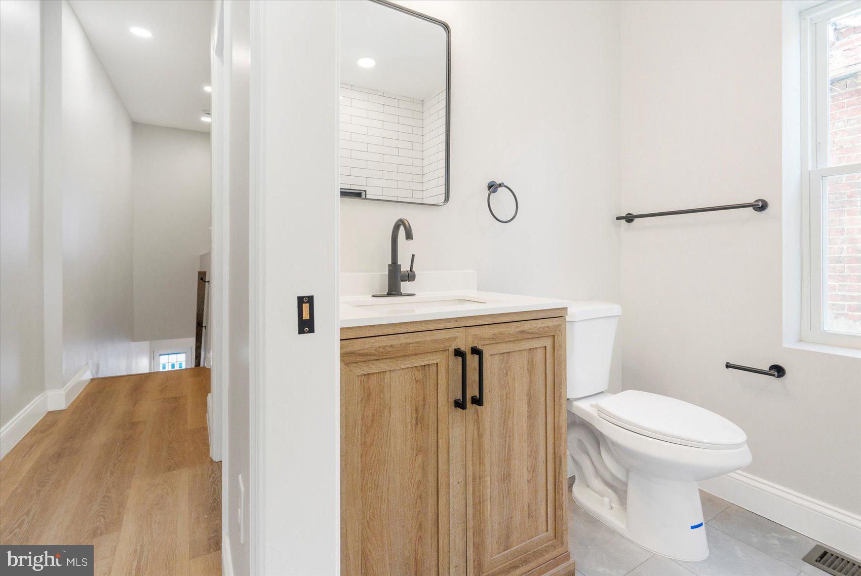 1415 East Lanvale Street Baltimore, MD 21213 - Photo 32 of 42 a bathroom with a sink toilet and shower