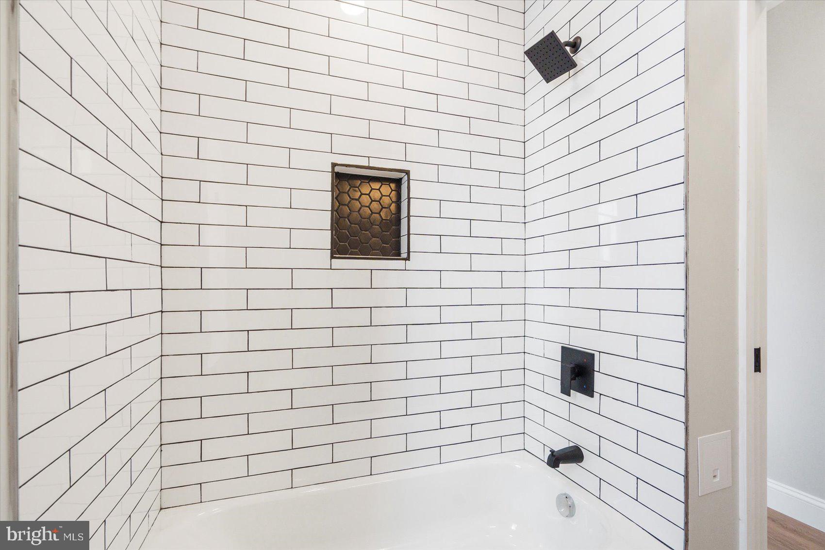 1415 East Lanvale Street Baltimore, MD 21213 - Photo 33 of 42 a bathroom with a bathtub and shower