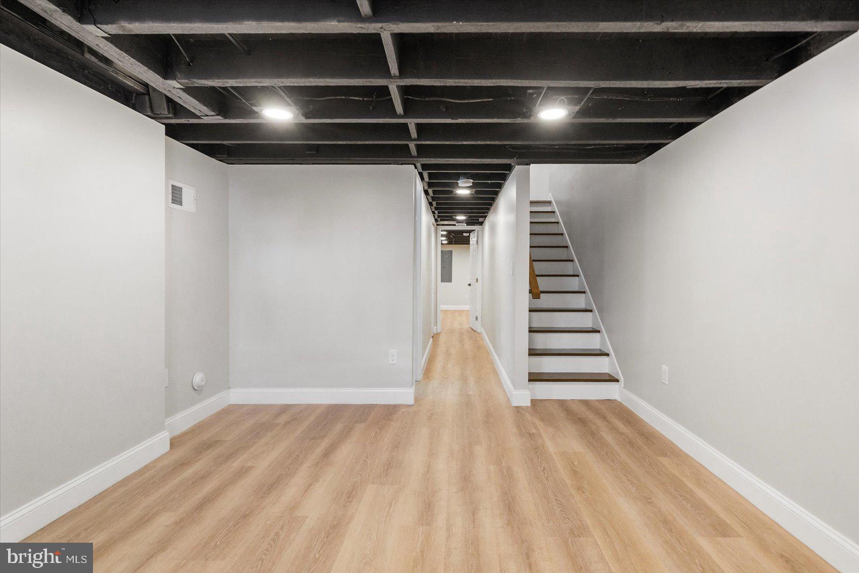 1415 East Lanvale Street Baltimore, MD 21213 - Photo 34 of 42 a view of room with stairs and wooden floor