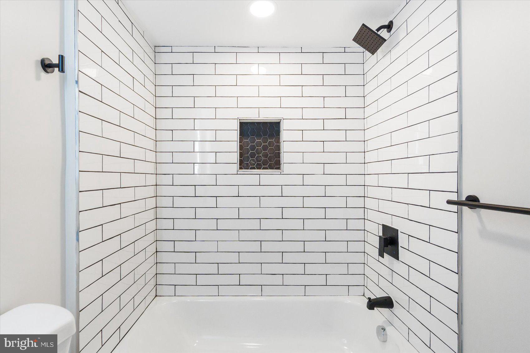 1415 East Lanvale Street Baltimore, MD 21213 - Photo 38 of 42 a bathroom with a bathtub and shower