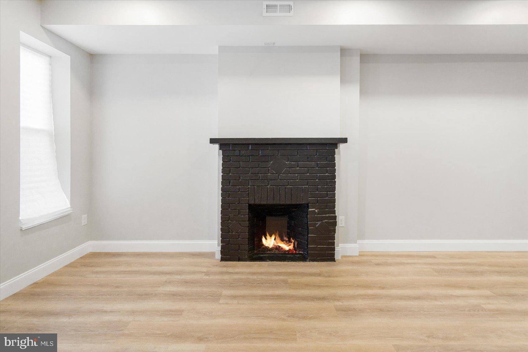 1415 East Lanvale Street Baltimore, MD 21213 - Photo 6 of 42 a living room with a fireplace and a fireplace