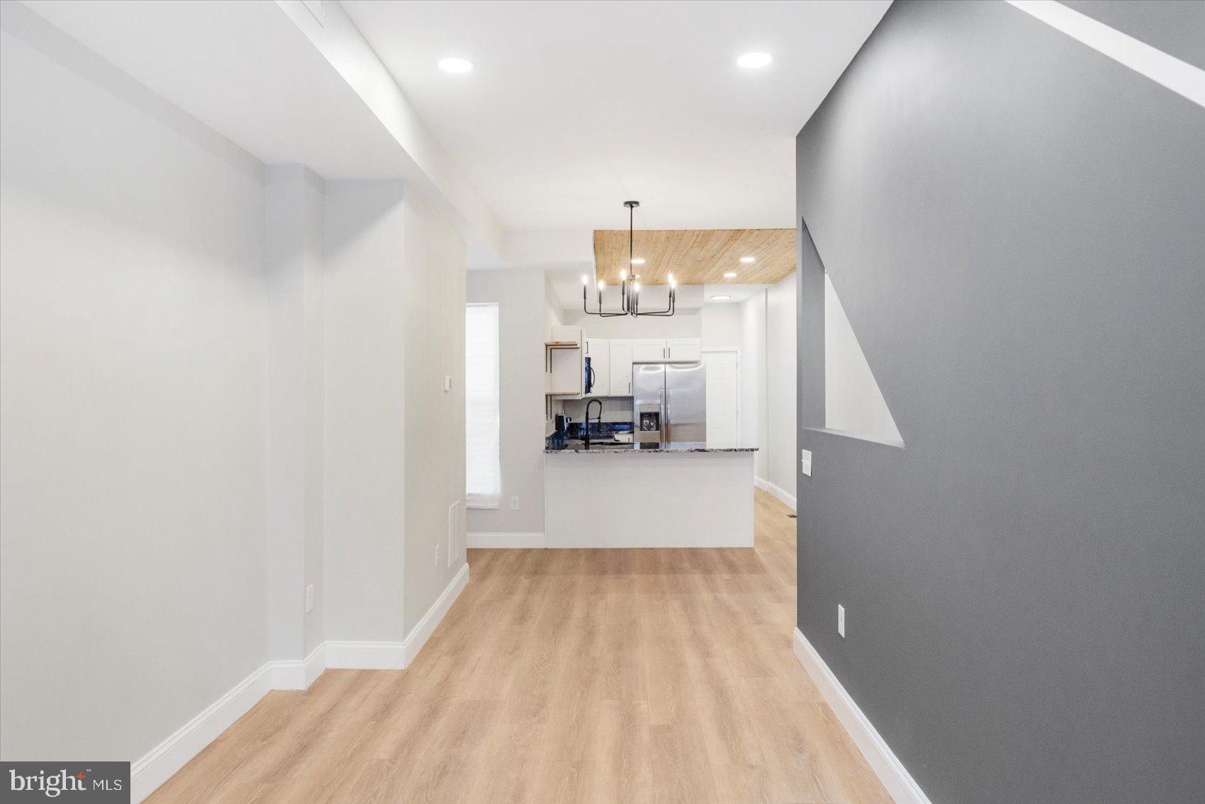 1415 East Lanvale Street Baltimore, MD 21213 - Photo 8 of 42 a view of a hallway to a livingroom with furniture