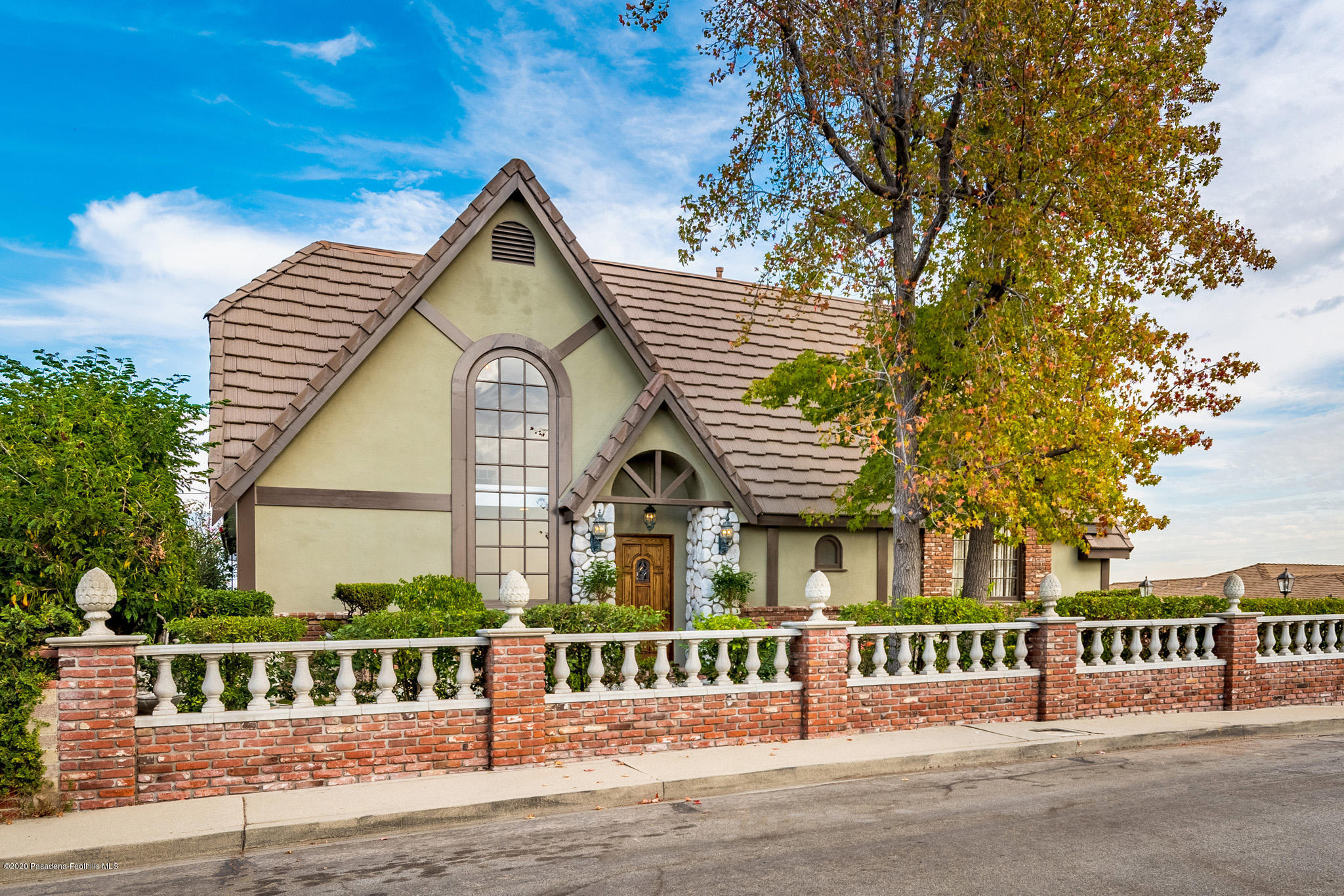 a front view of a house with a garden