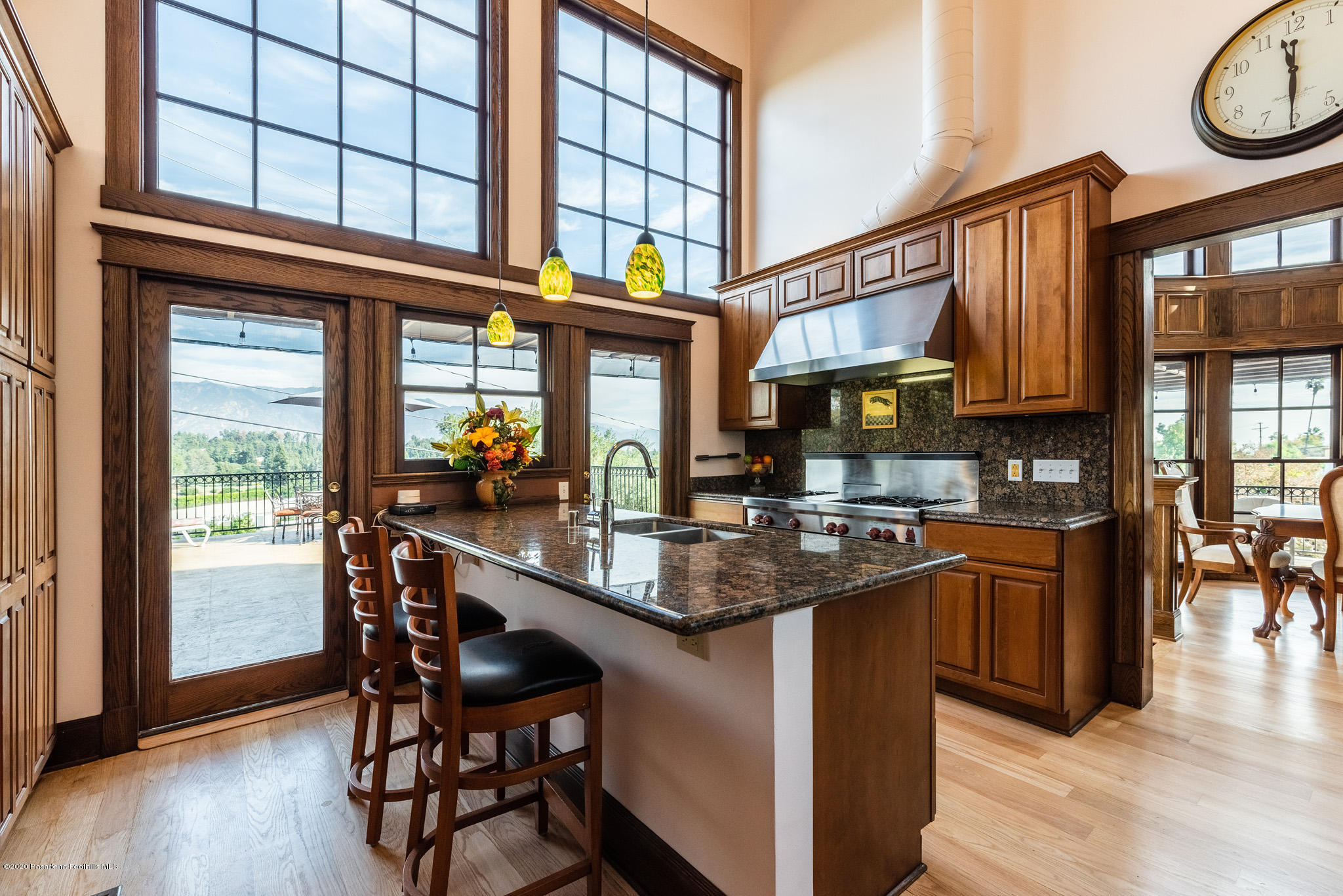 150 Sequoia Drive Pasadena, CA 91105 - Photo 13 of 53 a kitchen with stainless steel appliances granite countertop a table chairs in it and wooden floors