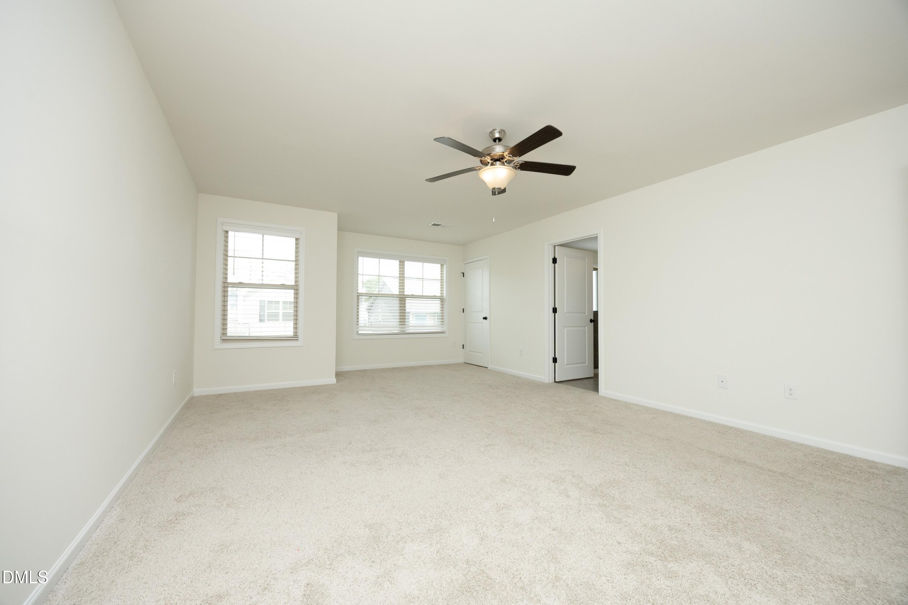 824 Country Downs Road Wake Forest, NC 27587 - Photo 4 of 41 an empty room with a window and a ceiling fan