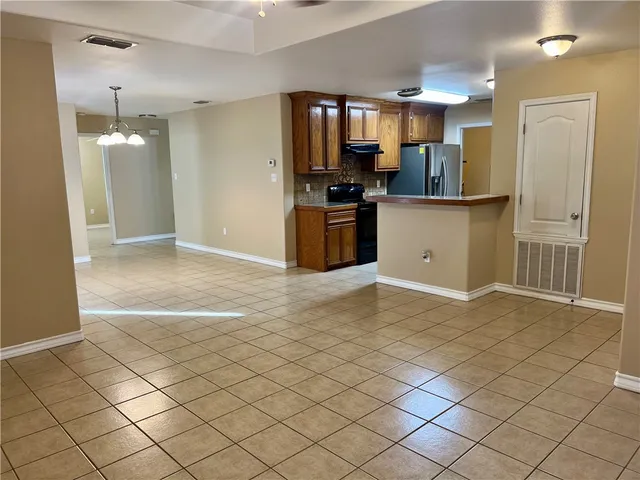 a open kitchen with cabinets and stainless steel appliances