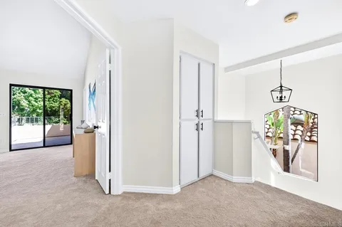 an empty room with windows and chandelier