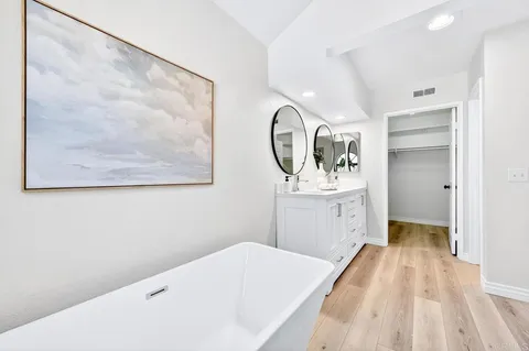 a hallway with a bed and a mirror