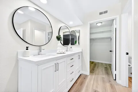 a bathroom with a double vanity sink and a mirror