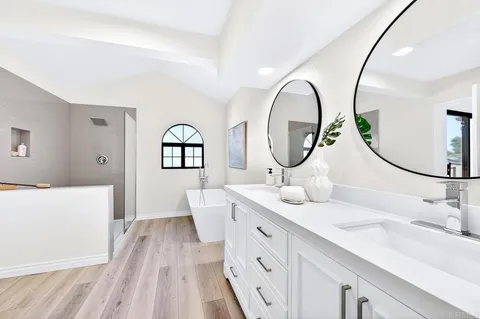 a spacious bathroom with a double vanity sink and a mirror