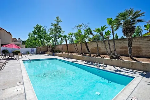 a view of a backyard with a tub and potted plants