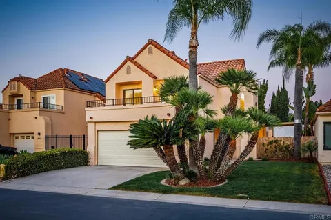 a view of a house with a yard and plants