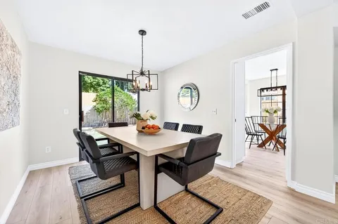 a view of a dining room and hall with furniture