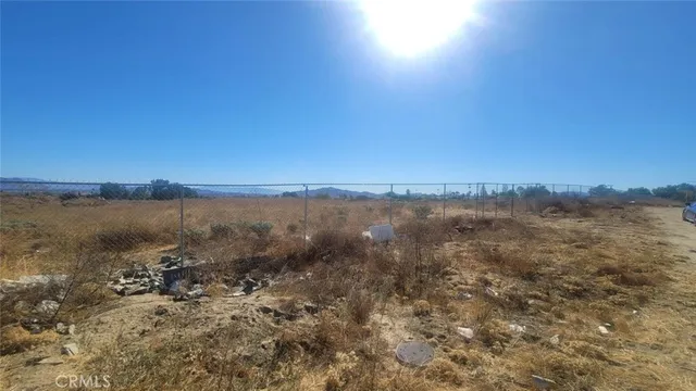 a view of a yard with wooden fence