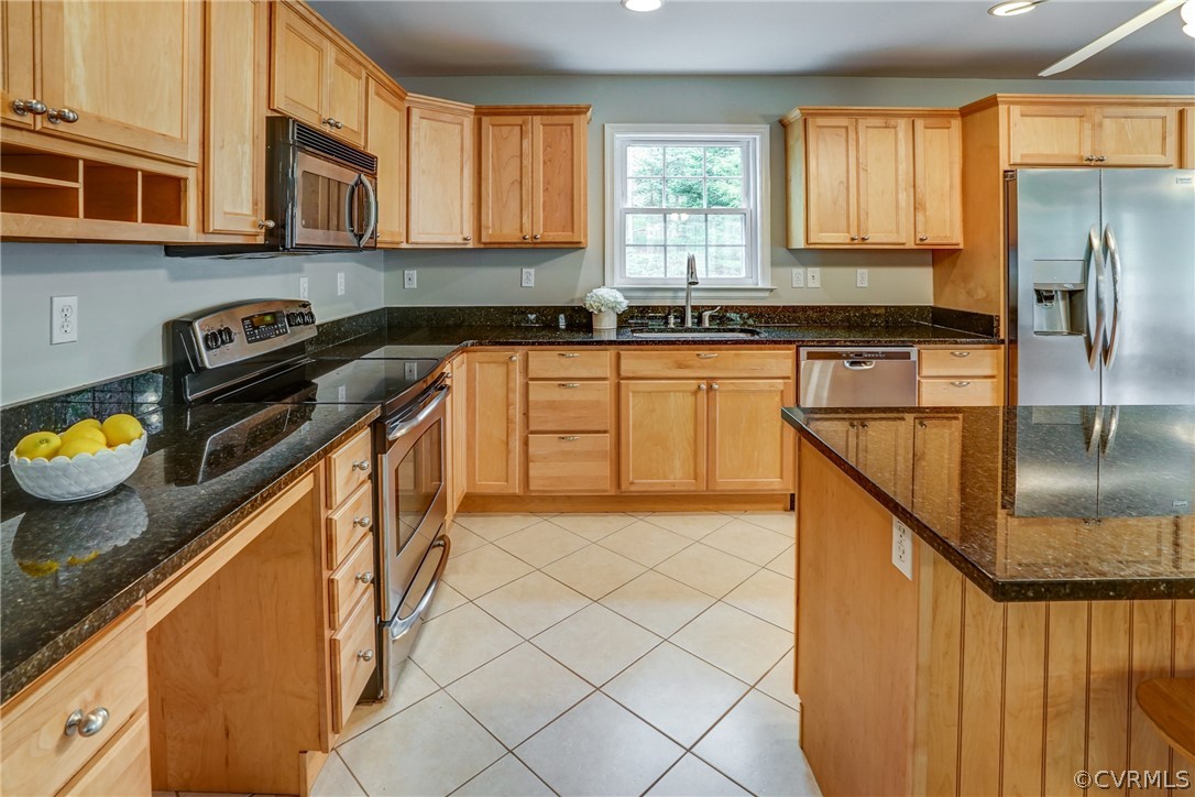 2855 Red Lane Road Powhatan, VA 23139 - Photo 11 of 42 a kitchen with stainless steel appliances granite countertop a stove a sink and a microwave