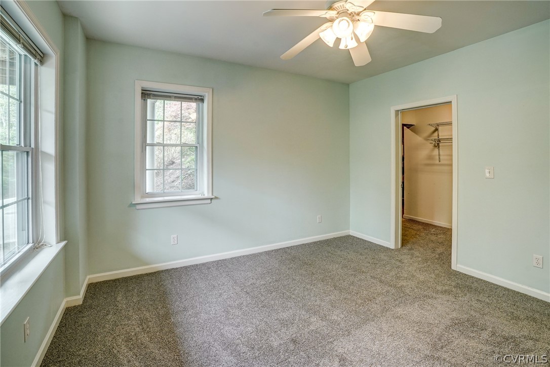 2855 Red Lane Road Powhatan, VA 23139 - Photo 23 of 42 an empty room with windows and chandelier fan
