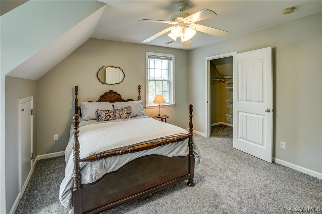 2855 Red Lane Road Powhatan, VA 23139 - Photo 28 of 42 a bedroom with a bed and a chandelier