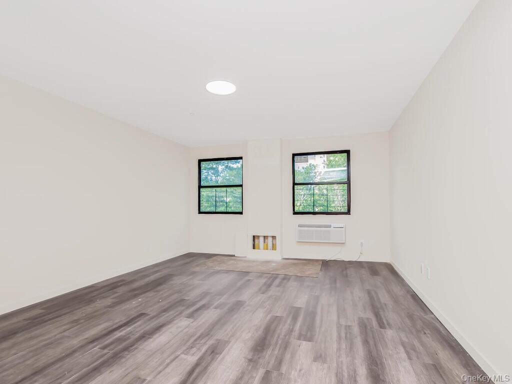 409 Warburton Avenue, Unit 5A Yonkers, NY 10701 - Photo 4 of 13 Spare room with wood finished floors and a wall unit AC