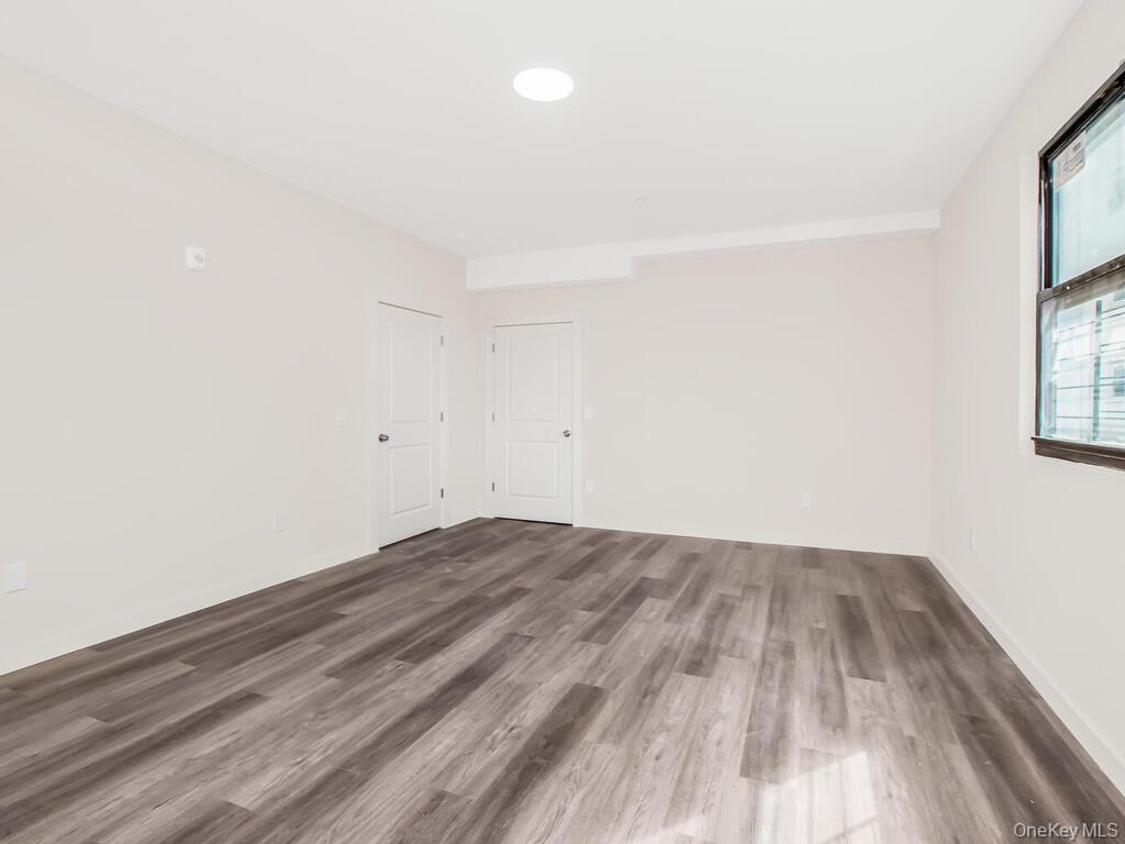 409 Warburton Avenue, Unit 5A Yonkers, NY 10701 - Photo 6 of 13 Empty room with wood finished floors and recessed lighting