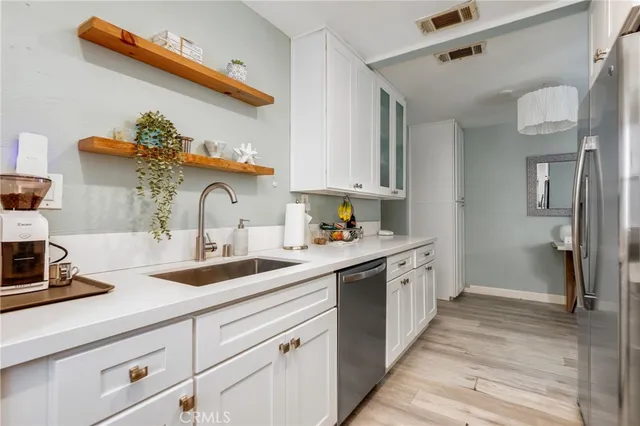 a kitchen with a sink cabinets and window